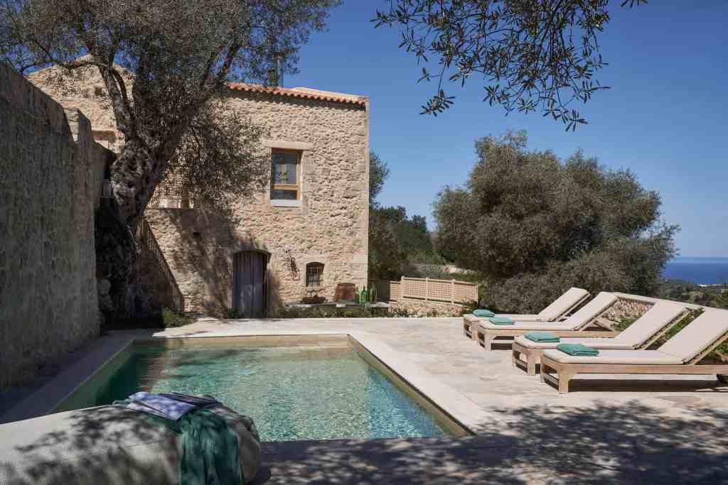 stone house and pool with ocean views